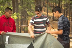 Boys set up a tent
