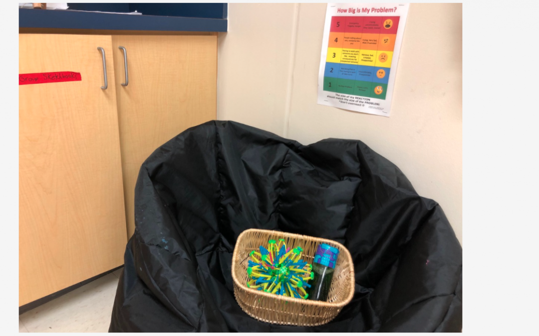 a black bean bag chair in the corner of a classroom with a basket that contains an expanding mini sphere and lava flow bottle
