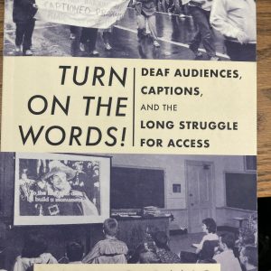 Book cover: picture of a classroom with students in desks watching a movie