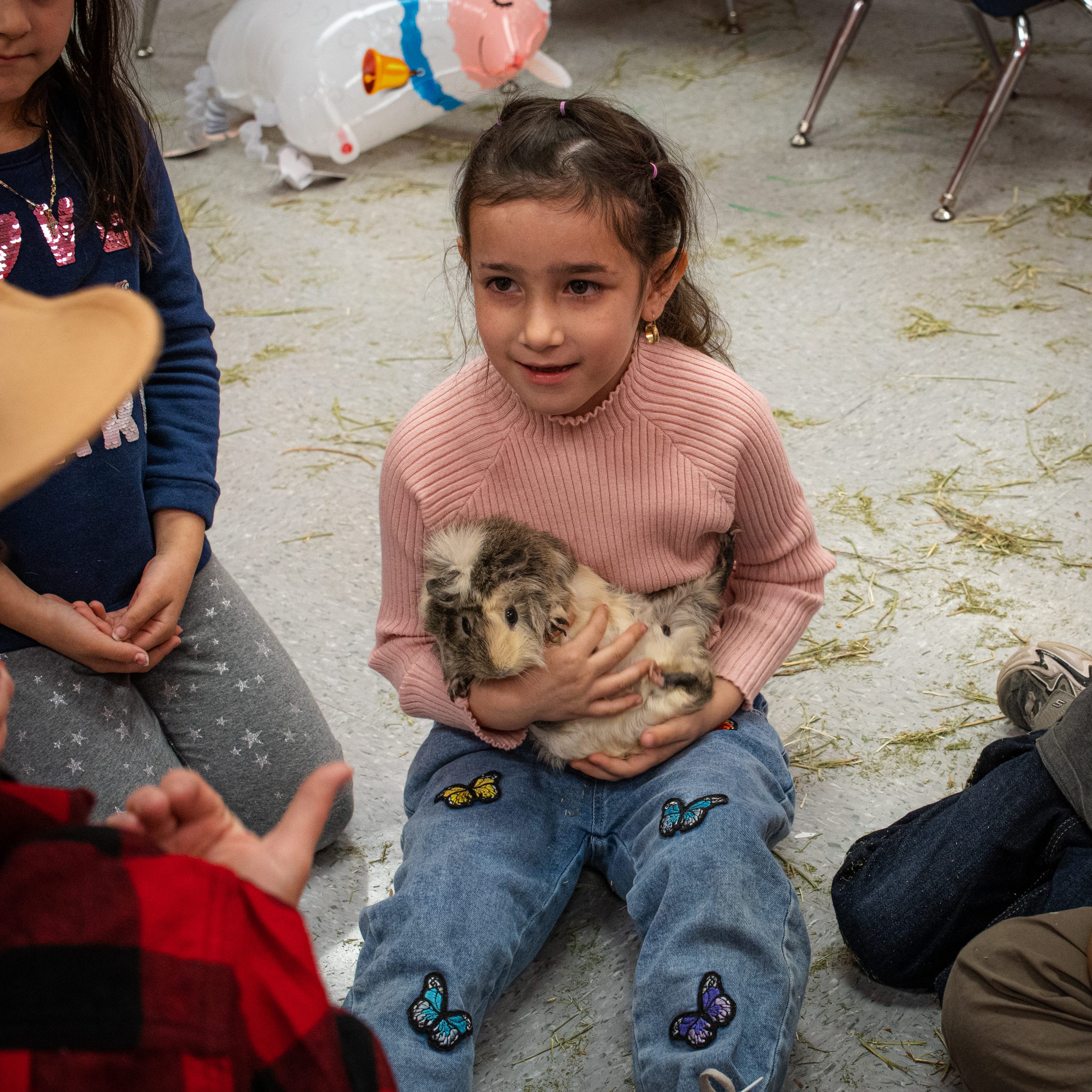 A student is seen holding an animal and smiling