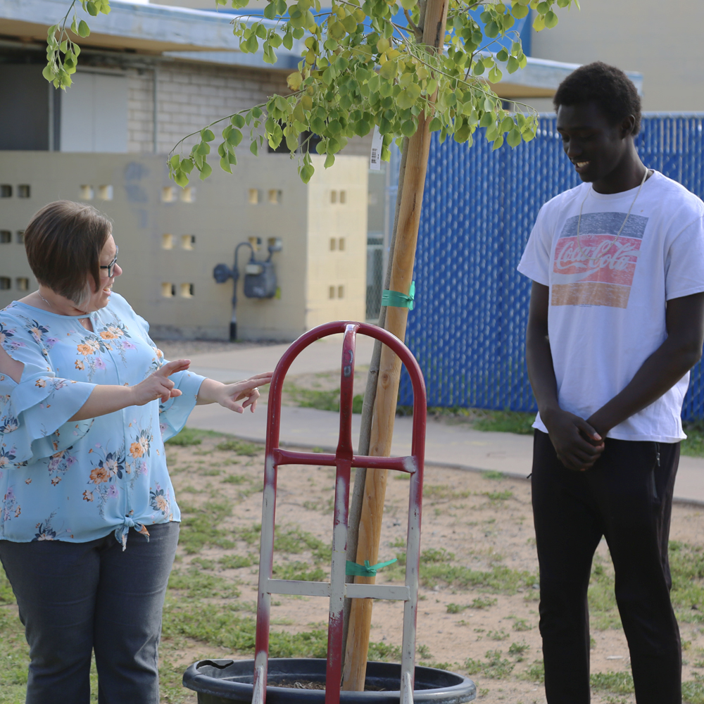 PDSD Principal Jill Voit asks PDSD senior, Kotu Salih, if he is ready for the first honorary groundbreaking of the first tree to be planted.