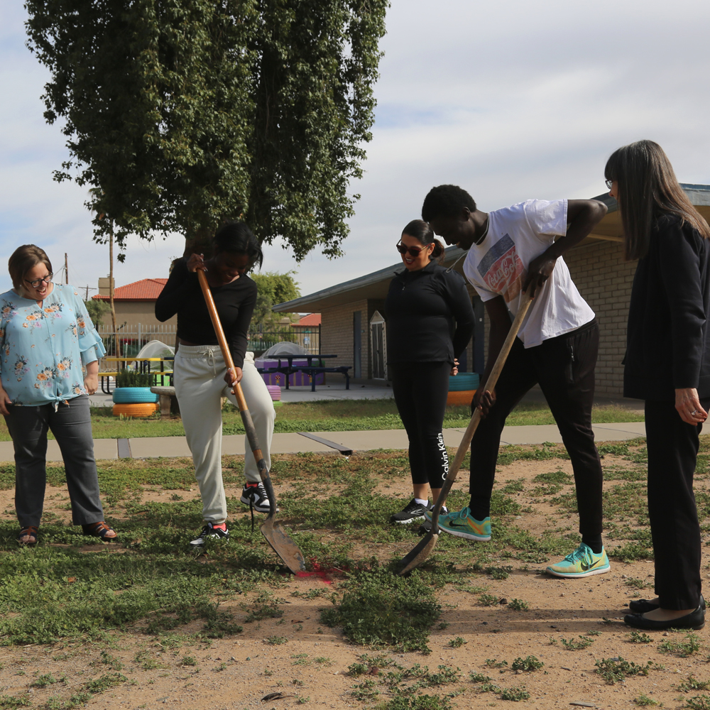 Principal Jill Voit, Councilwoman Betty Guardado and Superintendent Annette Reichman look on as PDSD students, Kotu Salih and Miracle Brooks, break ground for the first tree to be planted on the PDSD Campus