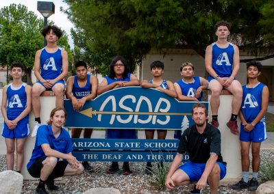 The ASDB track team posing for a photo with the ASDB sign