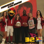Derrick Coleman poses for a photo with Superintendent Annette Reichman, PDSD Principal Courtney Fritz, two cheerleaders and the Cardinals mascot