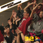 PDSD students cheer and wave their hands in the air