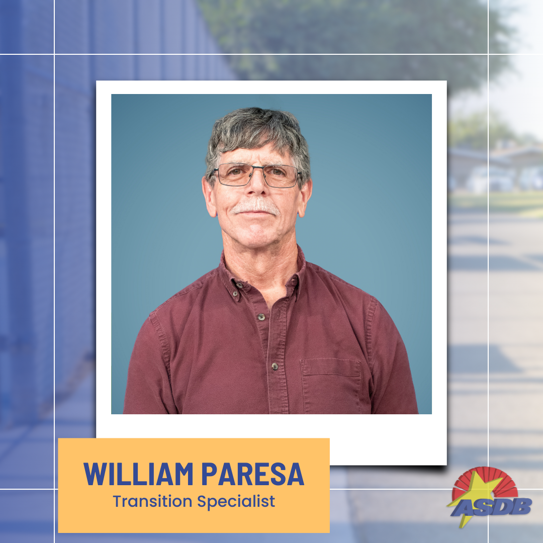 A portrait photo of Transition Specialist William Paresa. He has short, salt-and-pepper hair, glasses, and is wearing a maroon button-up shirt.